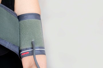 The device for independent measurement of blood pressure. Health in quarantine. Home tonometer. Close up. Hand with tonometer.