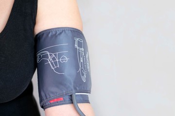 The device for independent measurement of blood pressure. Health in quarantine. Home tonometer. Close up. Hand with tonometer.