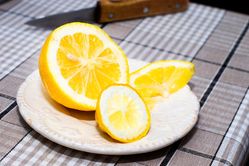 yellow sliced lemon lies on the saucer