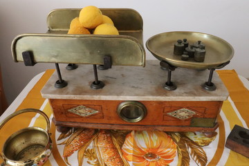 An old two plate scale weighing some lemons