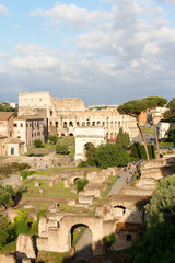 Fototapeta premium Aerial panoramic cityscape view of the Roman Forum and Roman Colosseum during sunset in Rome, Italy