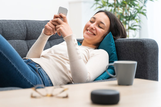 Woman using smart speakers for home automation technology