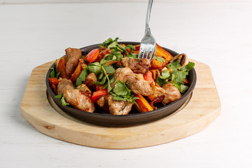 fried potatoes with meat served in a frying pan