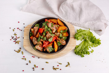 fried potatoes with meat served in a frying pan