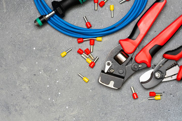 Tools and tips of different sizes and colors for crimping stranded electrical wires. Crimping...