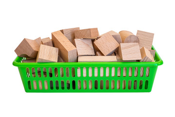 Wooden geometric shapes in a plastic green basket