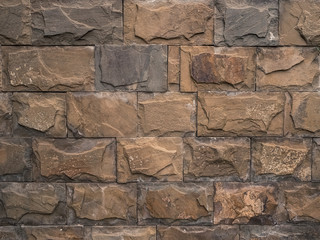 multi-colored large bricks of different shapes close-up - background