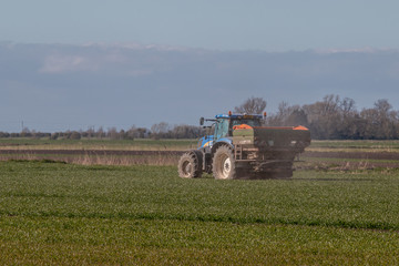 tractor fertilizer in a field , countryside