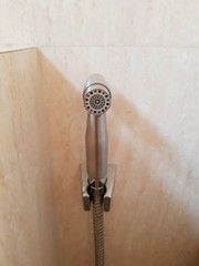 Closeup of stainless steel toilet hose.
Housewares concept.
