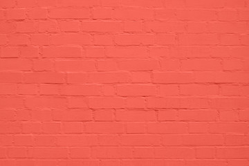 texture: old cracked brick wall painted in coral paint