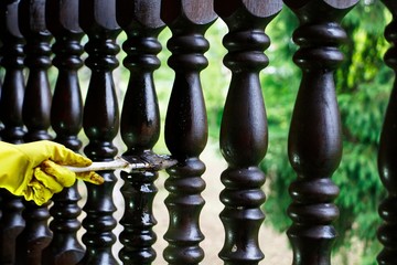 Coloring fence with brush