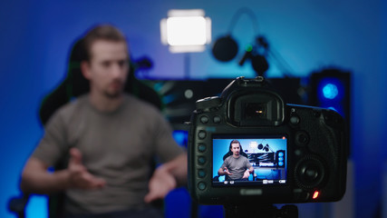 Tech computer influencer shooting video with photo camera 4K - obrazy, fototapety, plakaty