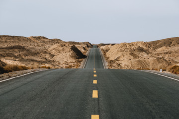 Gobi desert road on vast dry wilderness