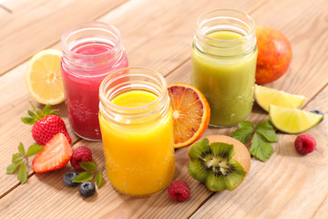 fruit juice- berry fruit, orange, kiwi, smoothie and straw