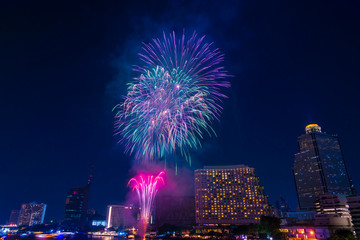 Beautiful firework display for celebration happy new year and merry christmas with  Twilight night and firework lighting in bangkok cityscape background, Thailand.