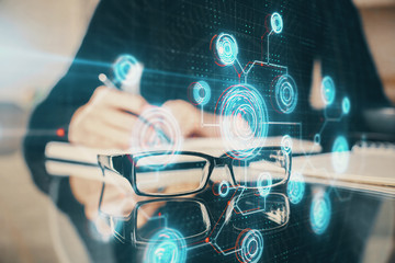 Double exposure of writing hands on background with data solution hologram on front. Technology concept. Side view.