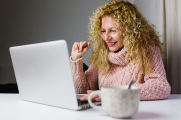 Mature woman making a video call from her laptop at home during quarantine