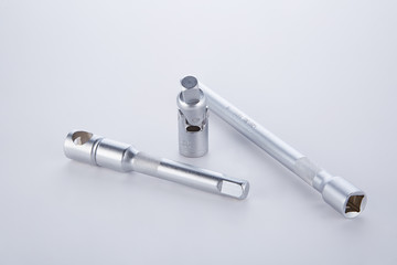 Screwdrivers and angled socket head on a white background