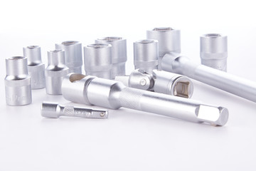 Set of socket head in different sizes with a key on a white background