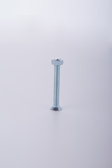 Long screw with knurled steel bolt on a white background