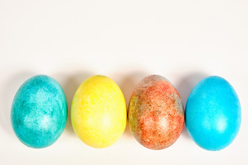 Multicolored, painted Easter eggs on a white background. space for text