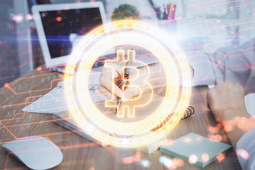 Cryptocurrency hologram over hands taking notes background. Concept of blockchain. Multi exposure