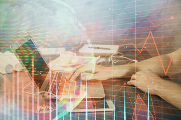 Double exposure of forex chart with man working on computer on background. Concept of market analysis.