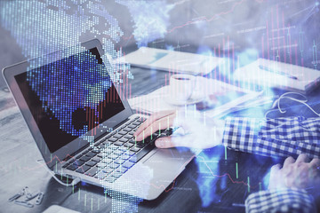 Double exposure of forex chart with man working on computer on background. Concept of market...