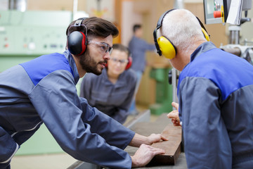 carpenter with apprentice in training period