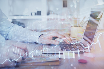 Multi exposure of stock market chart with man working on computer on background. Concept of financial analysis.
