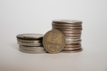 coin worth two pennies of the ussr. Coin stands vertically near other coins piled in a stack