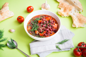 Lobio-vegetable stew of red stewed beans, paprika and herbs, a traditional dish for Caucasian home cooking. Selective focus.
