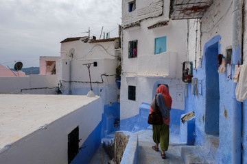 Alone woman traveling in blue city of  Chefchaouen,Morocco.
