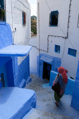 Alone woman in blue city of  Chefchaouen,Morocco.