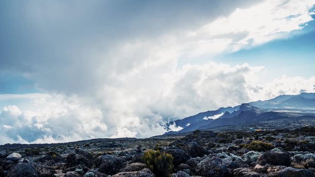 Timelapse view of Kibo with Uhuru Peak (5895m, highest mountain in Africa) at Mount Kilimanjaro, Kilimanjaro National Park. Beautiful landscape with clouds floating over the  volcano.