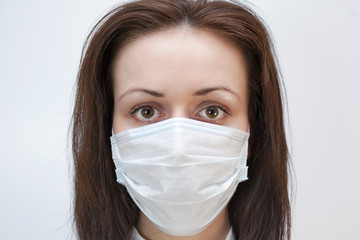 Young woman in protective medical mask