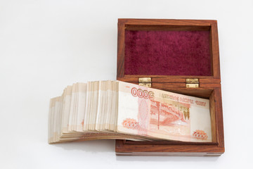 Russian banknotes of five thousand rubles in large quantities in a wooden box