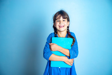 Fototapeta premium indoor portrait of young child girl with laptop, isolated studio shot, online education