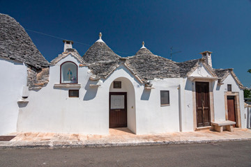 Panoramic view of the streets with the characteristic trulli of the town of Alberobello in Puglia,...