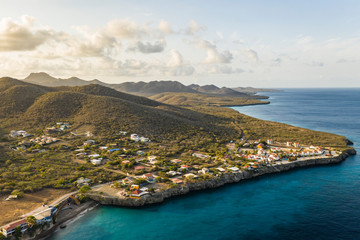 Aerial view of coast of Curacao in the Caribbean Sea with turquoise water, cliff, beach and beautiful coral reef