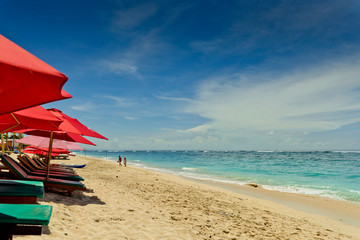 Young couple relax in vacation on the tropical beach. Pandawa beach, Bali, Indonesia.