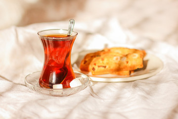 Breakfast in bed. Turkish tea in a traditional glass and cookies