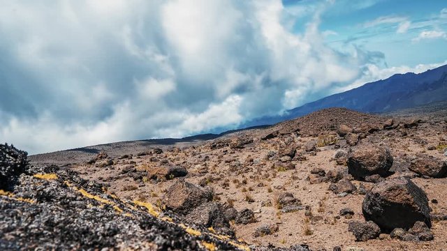 Timelapse view of Kibo with Uhuru Peak (5895m, highest mountain in Africa) at Mount Kilimanjaro, Kilimanjaro National Park. Beautiful landscape with clouds floating over the  volcano.