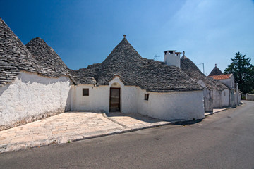 Fototapeta na wymiar Panoramic view of the streets with the characteristic trulli of the town of Alberobello in Puglia, Italy.