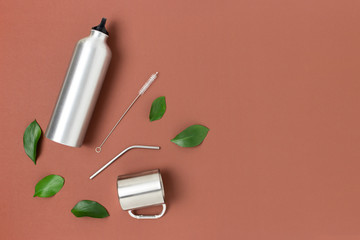 Zero waste accessories for drinking on a brown background. Plastic free concept with copy space.