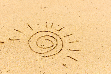 Image of sun drawing on sand. Sandy background.