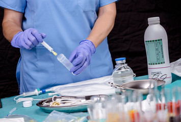 Nurse preparing medication for parenteral nutrition in a hospital, conceptual image