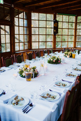 Decorative table setting for many people to celebrate family party, baptism, wedding 