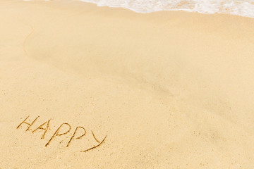 Fototapeta na wymiar Happy sign and wave on a sandy beach. Background close up.