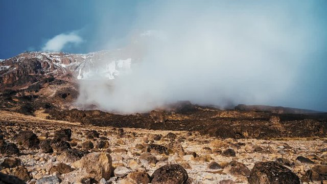 Timelapse view of Kibo with Uhuru Peak (5895m, highest mountain in Africa) at Mount Kilimanjaro, Kilimanjaro National Park. Beautiful landscape with clouds floating over the  volcano.